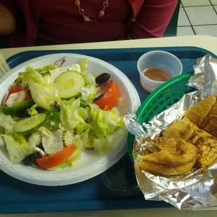 Tasty greek salad and a garlic roll.