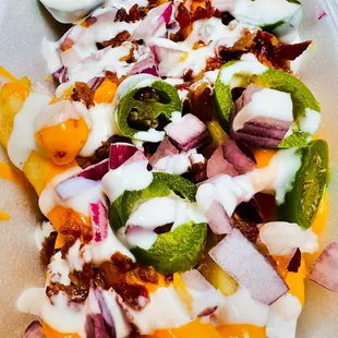 Loaded cheese French fries, jalapeño, homemade ranch dressing, onions, bacon