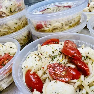 Favorite cold salad, fresh mozzarella, delicious tomatoes in a well seasoned garlic olive oil