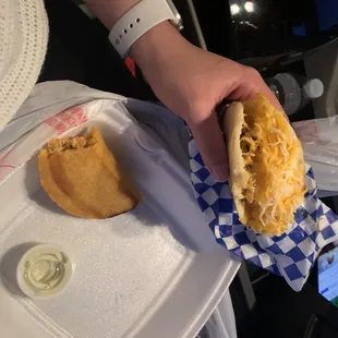 a person holding a sandwich