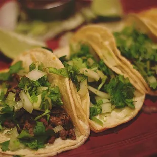 three tacos on a red plate