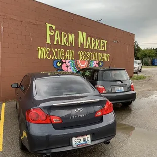 two cars parked in front of a building