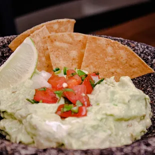 a bowl of guacamole and chips