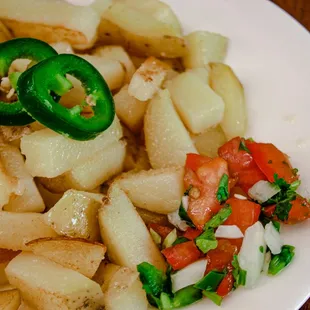 a plate of potatoes and jalapeno peppers
