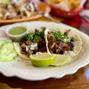 Carnitas taco and carne asada taco
