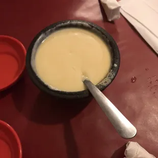a bowl of soup with a spoon in it