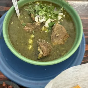 a bowl of soup and tortillas