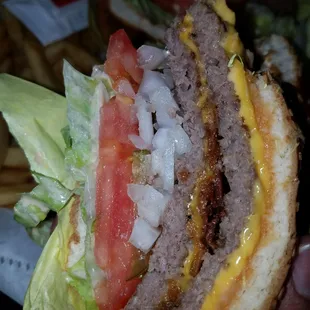 a hamburger with lettuce and tomatoes