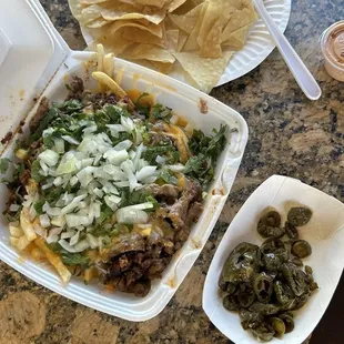 Asada Fríes with Chorizo, no tomatoes or lettuce, cilantro, onions, and chipotle sauce.
