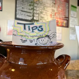 a brown pot with a note in it