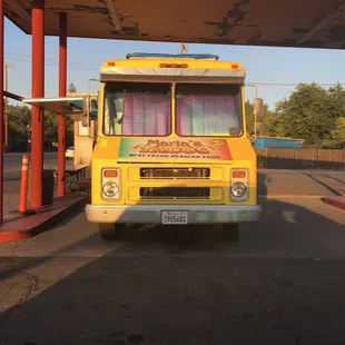 a taco truck parked at a gas station