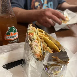 Tamarind Jarritos soda. Chicken quesadilla, and carnitas quesadilla halves. I split with a buddy thats eating his halves. Very good. $30.