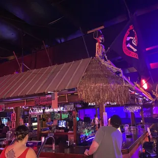 a tiki bar with a tiki roof