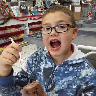 He loves his chocolate ice cream.