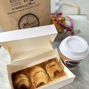 a box of pastries and a cup of coffee