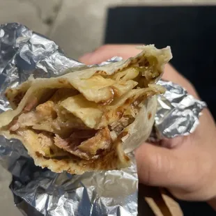 a hand holding a burrito