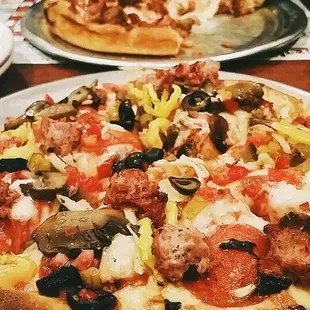 two pizzas on a table
