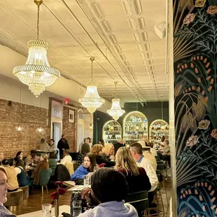 people sitting at tables in a restaurant