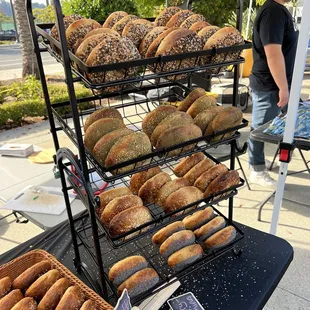 a man standing in front of a display of bagels