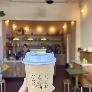 a person holding a cup of coffee