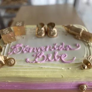 a cake decorated with gold and pink icing