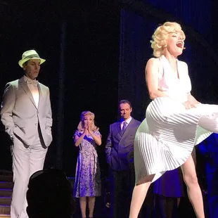 a woman in a white dress and a man in a gray suit