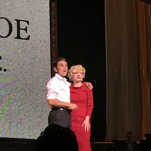 a man and woman on stage