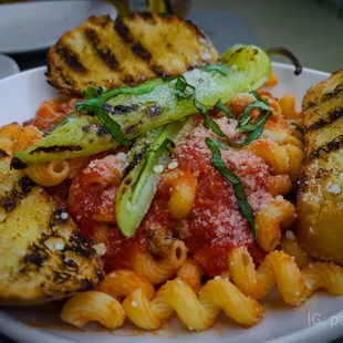 a plate of pasta and grilled bread