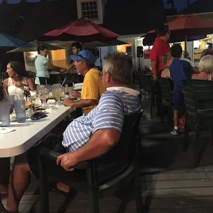 People on the deck listening to karaoke.