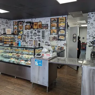 Inside the cafe with a display case of baked goods and counter