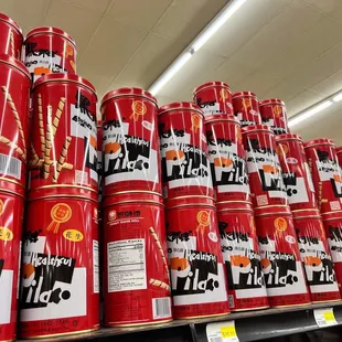 a large stack of red cans