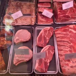 a variety of meats in a display case
