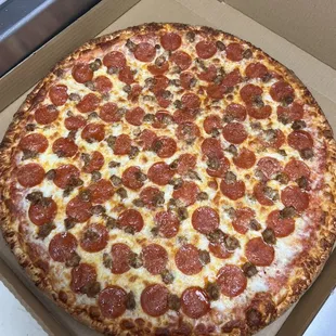 a large pepperoni pizza in a box