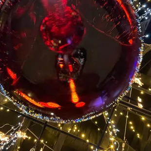 a person riding a bike through a lighted orb