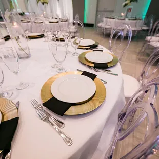 Tablescape Essentials! Luxe gold chargers and black linen napkins are one of our many table setting options