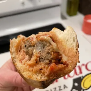 a hand holding a piece of bread