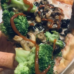 Added sriracha to their vegan cheese pizza with mushroooms, black olives and broccoli.