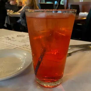 a glass of iced tea and a plate of food