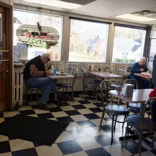 diners sitting at tables in a diner