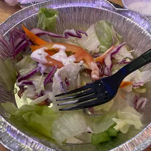 a salad in a foil container