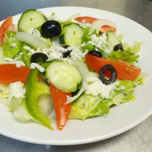 a salad with cucumbers and tomatoes