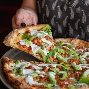 a woman holding a pizza
