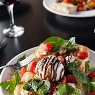 a plate of pizza and a glass of wine