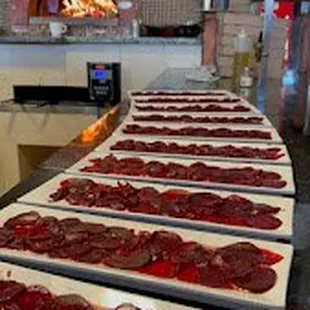 pizzas being prepared