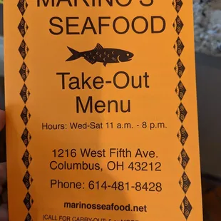 a hand holding a menu