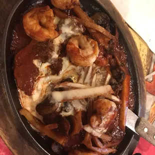 a pan of food with mushrooms and meat