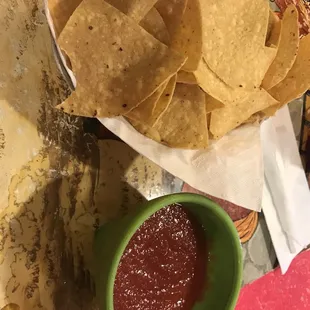 a bowl of chips and a bowl of ketchup