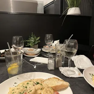 The stack of dirty dishes that sat on our table for the entire meal.