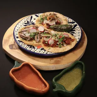 a plate of tacos and sauce