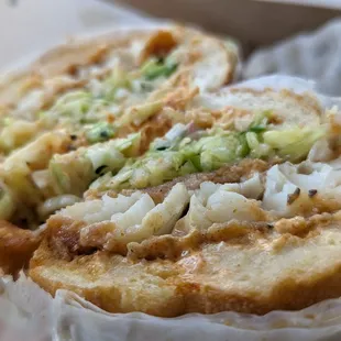 Baja Fish Sandwich - Daily Special.  Thicky, juicy fried cod with a fresh slaw and a savory, spicy kick.